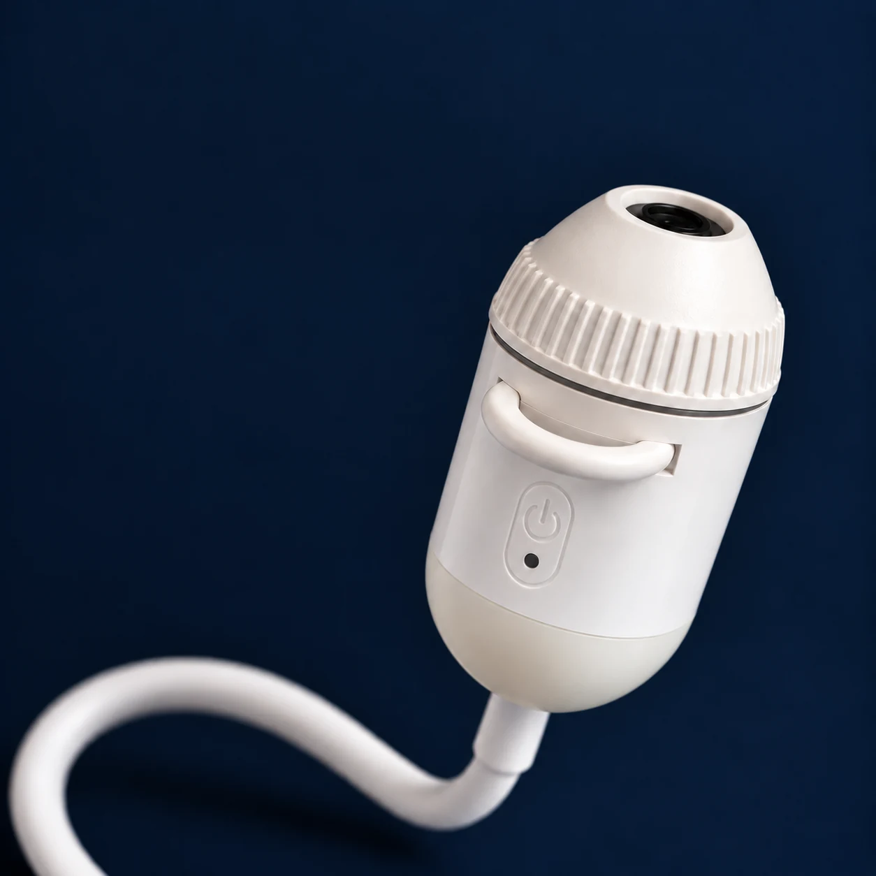 Recessed lens and ribbed manual focus collar on the white projector head